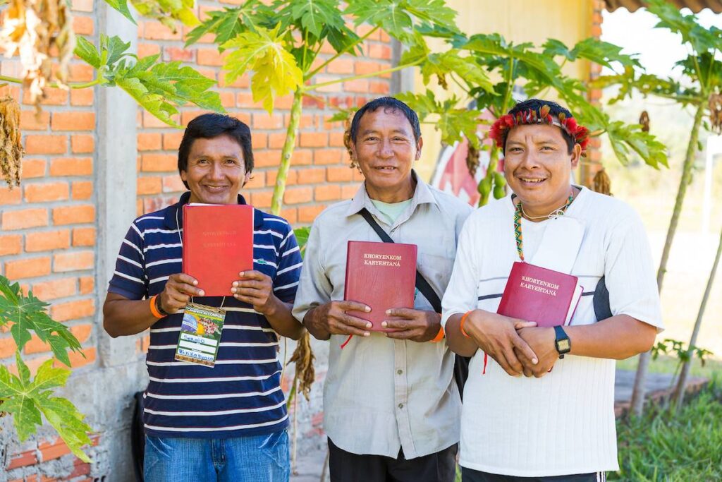 Three men holding Scripture.
