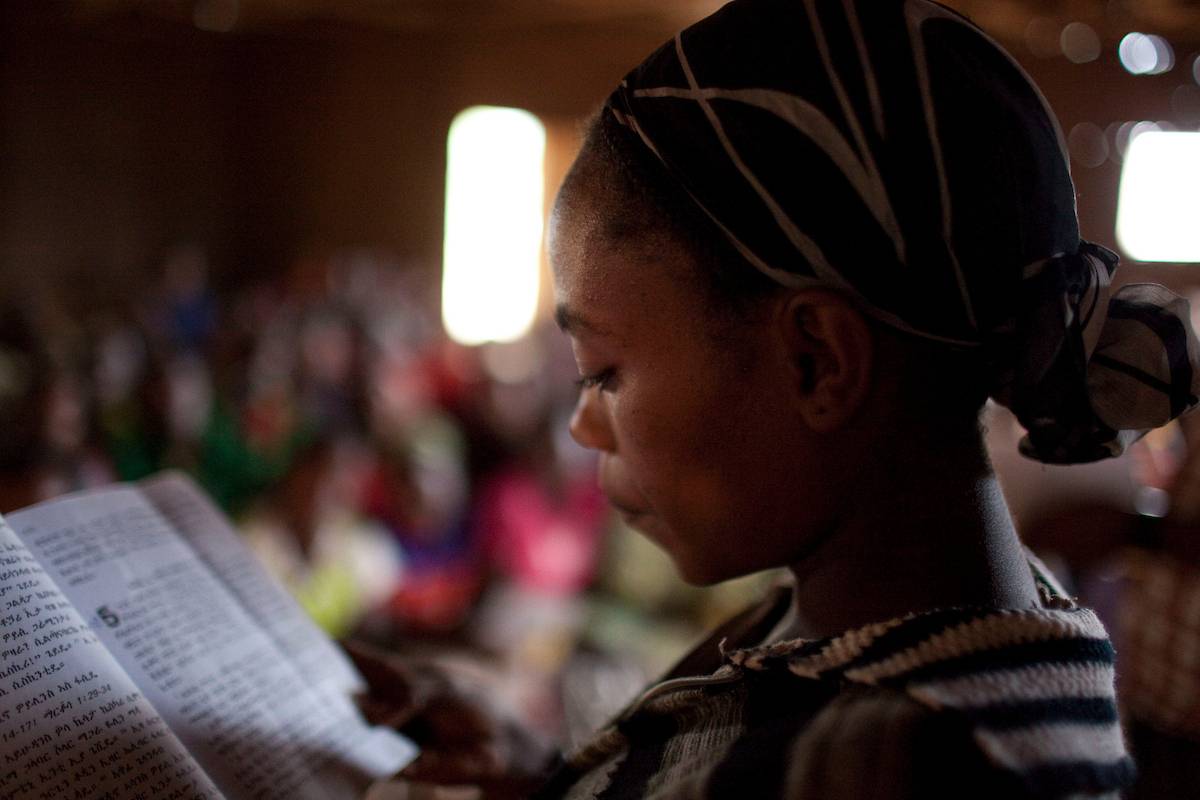 Ethiopian woman reading Bible.