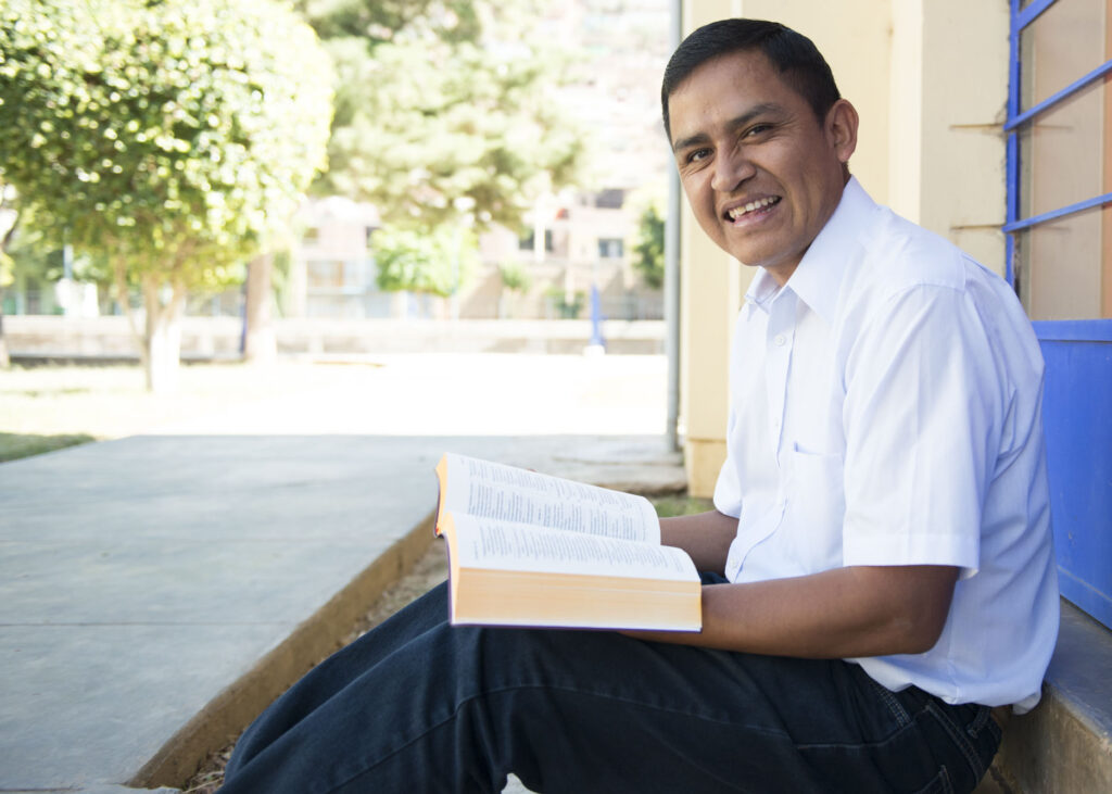 A translator reads the New Testament in Quechua.