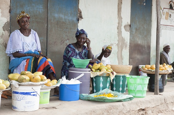 Women selling fruits and vegetables at their local market in Senegal.