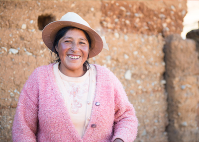 Woman in pink sweater blessed by Leonadra passing on literacy training and the love of God.