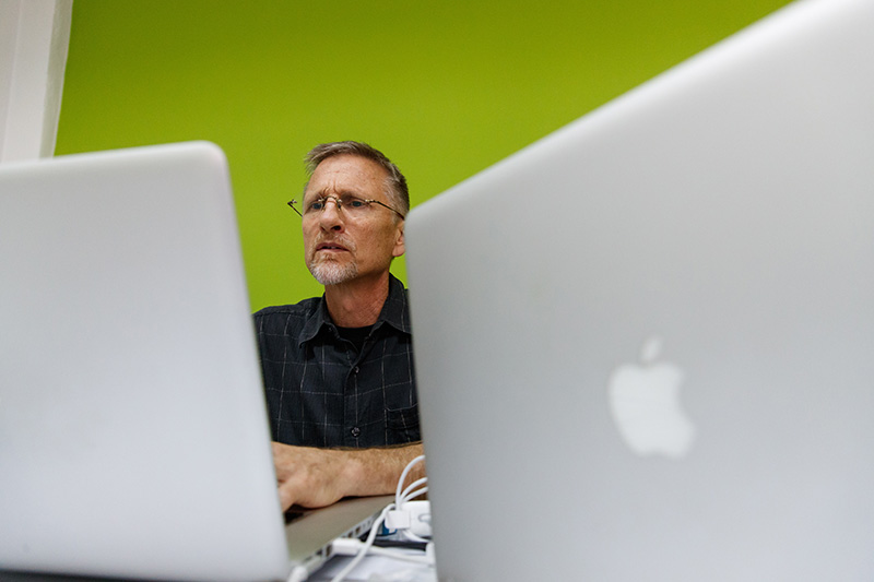 Mark Penner working on laptop