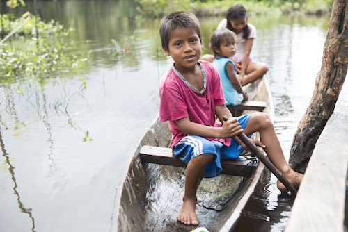 three kids sitting in a boat
