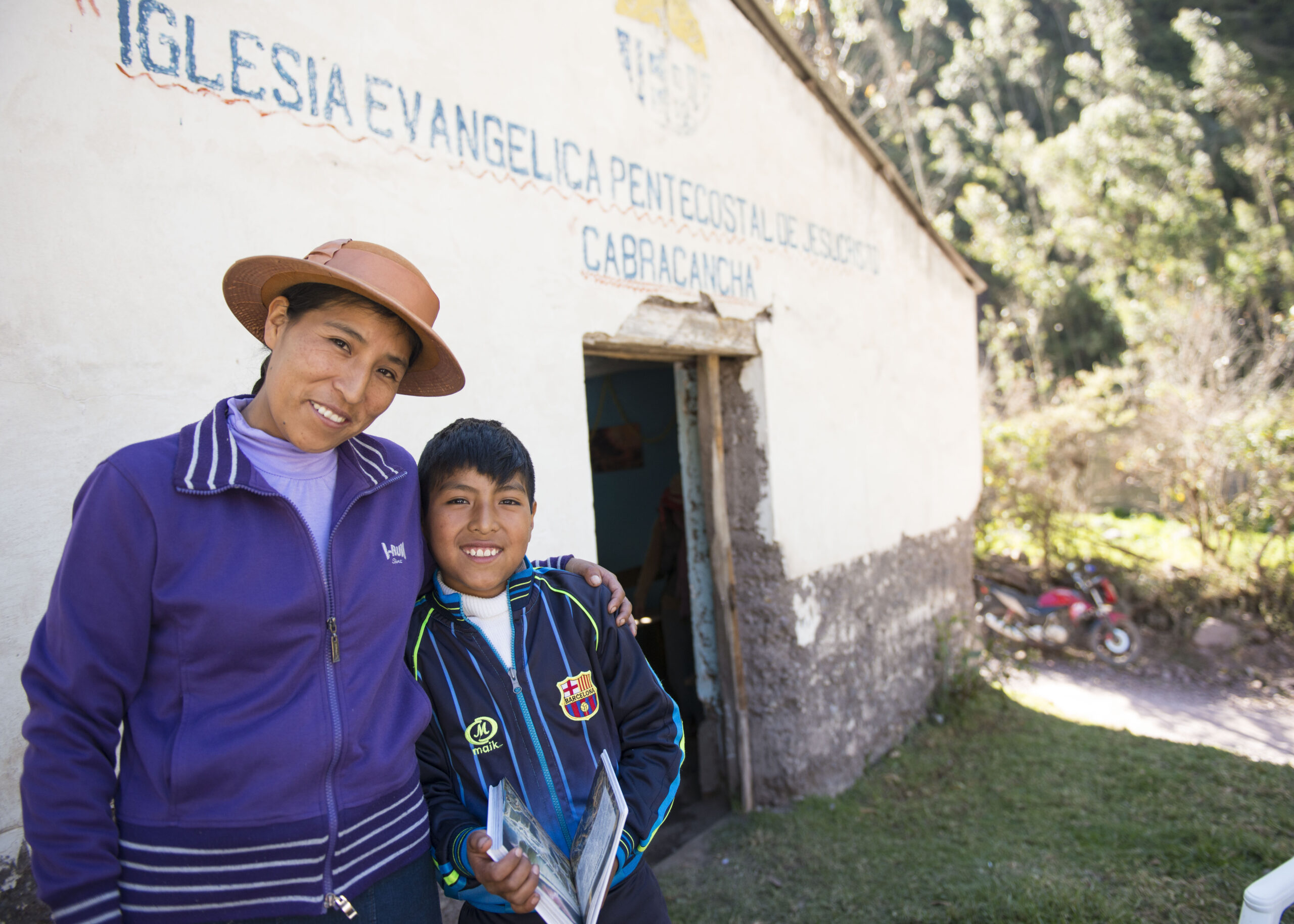 Viani and son outside their church building