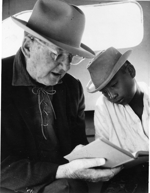 Uncle Cam reads the Bible with a young boy