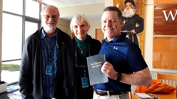 Sam Anderson holding the completed Rapa Nui New Testament with Bob and Nancy Weber.