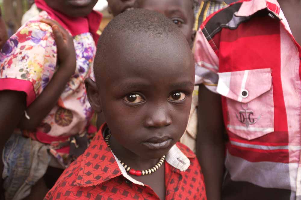 A boy surrounded by other children