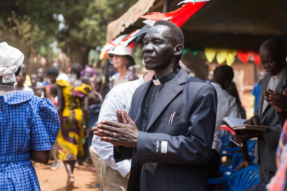 Bennett with his hands clasped