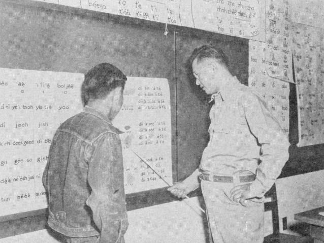 Roger Deal teaching a fellow Navajo to read.