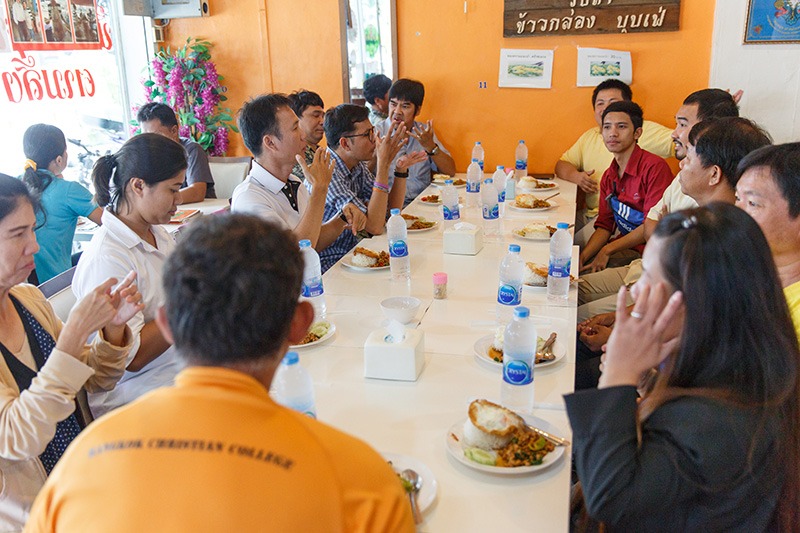 Group of Thai sign language translators sitting around a table for a meal.