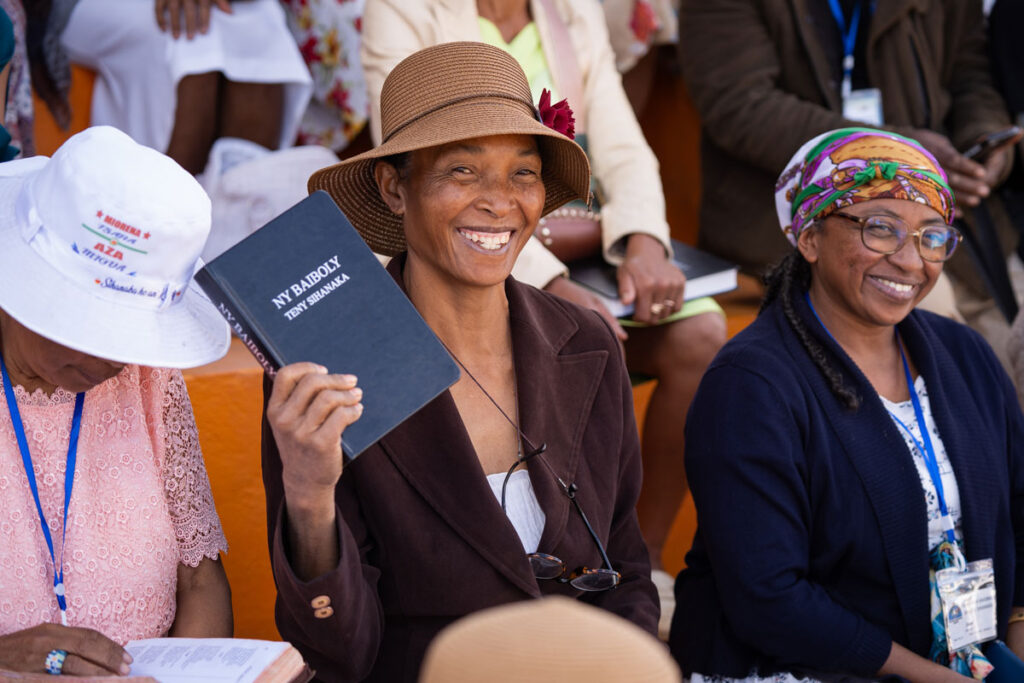 Woman holding up her new Sihanaka Bible.