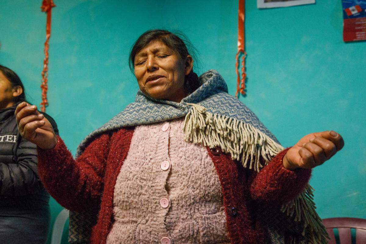A woman prays and worships.