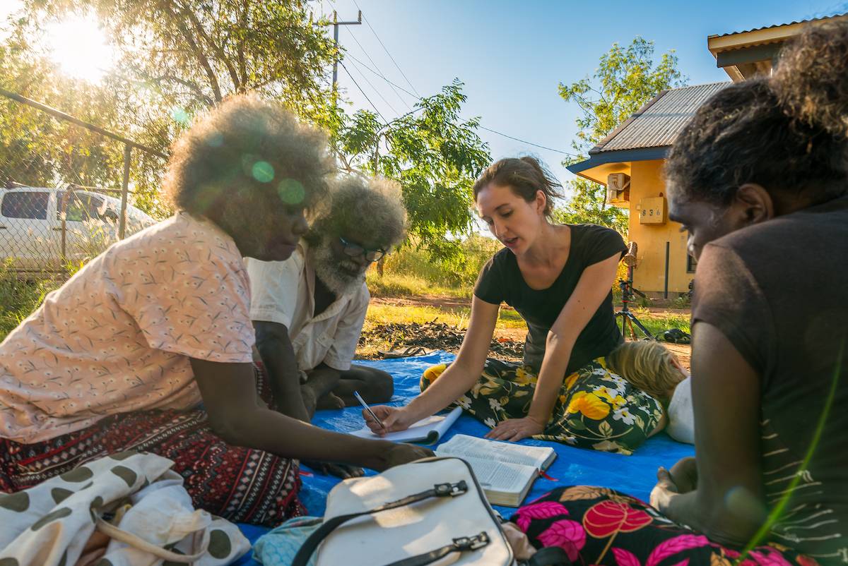 Woman works with local people on a language survey.