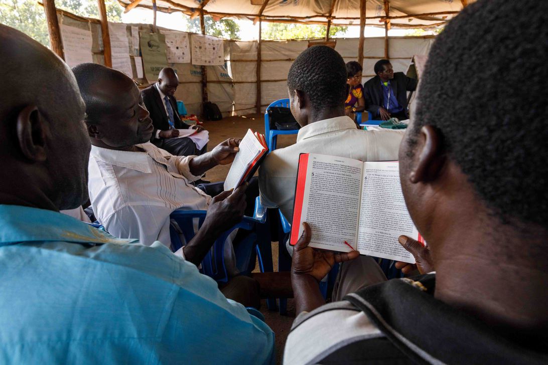 In an advanced literacy class, literacy specialist Elisa
                                Anyani (back left) has students read the Keliko New Testament which sparks
                                meaningful discussions.