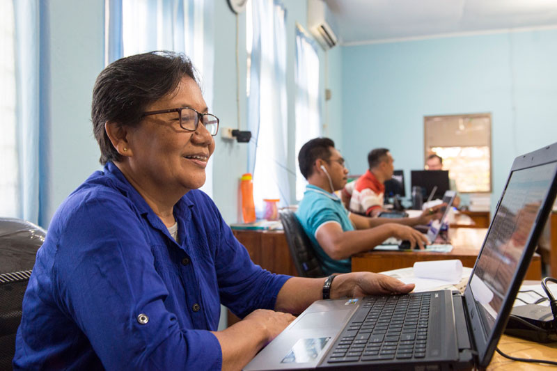 The Ambonese Malay team working on laptops.