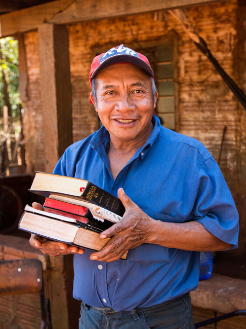 Translator holding translated Scripture.