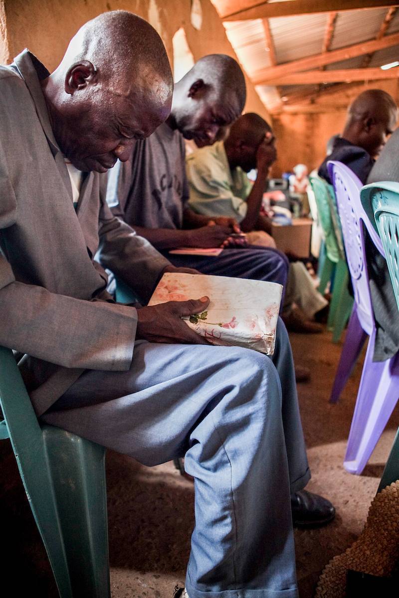 Man praying in a church service.