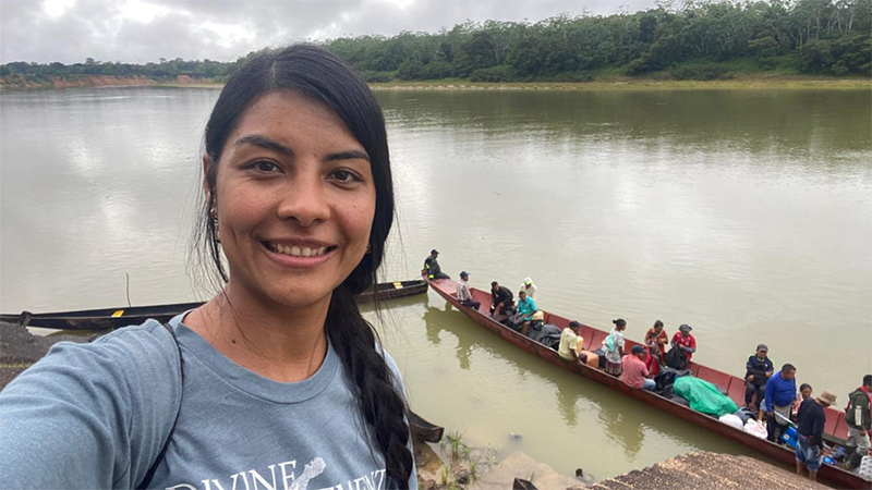 Jenniffer Ortiz beside a river in the Amazon.