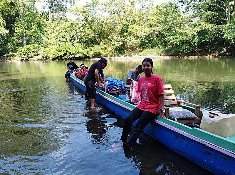 Photo of Jenniffer beside a canoe.
