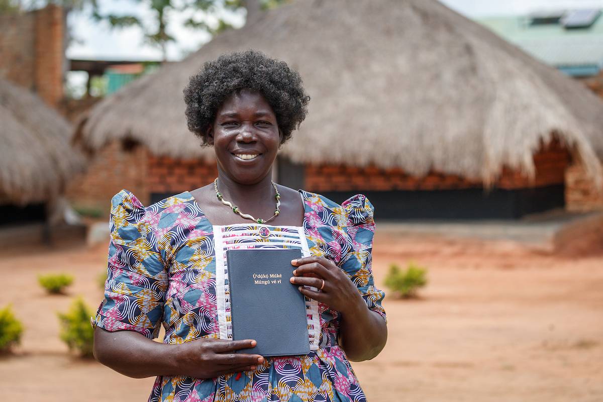 Keliko woman holding a New Testament.