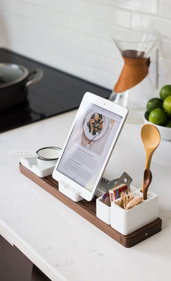 An ipad in a stand on kitchen countertop, displaying a recipe