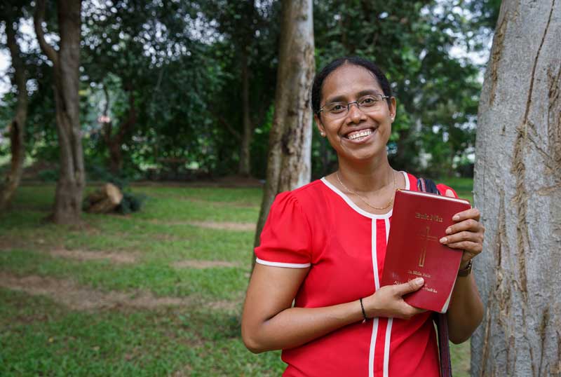 Misirani holding the Helong New Testament