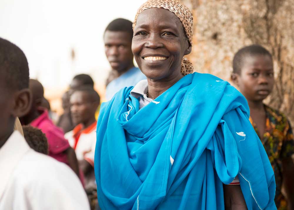 Woman smiling with a group around her