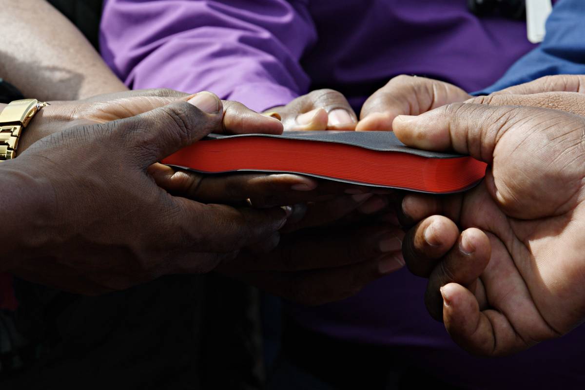 Hands holding a bible.
