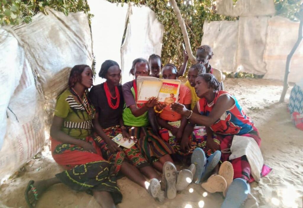 Daasanach women reading.
