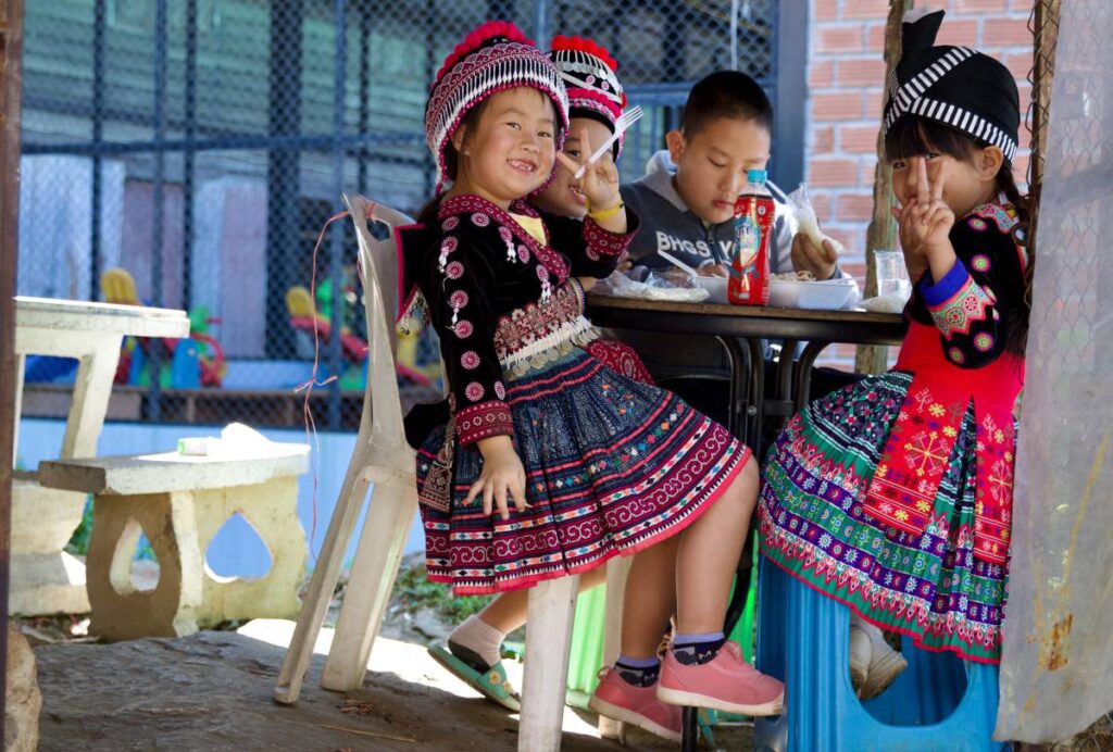 Kids in Thailand smiling.