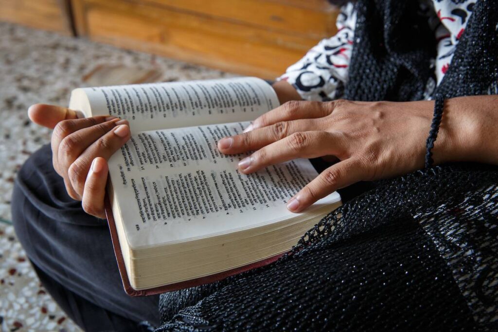 Woman's hands holding Bible.